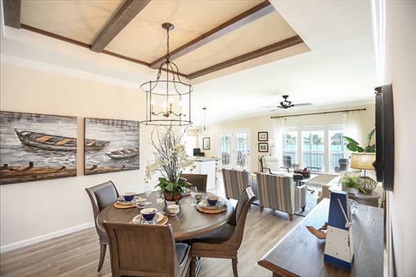 Rexmere Luxury series dining area with tray ceiling featuring beautiful exposed wooden beams.